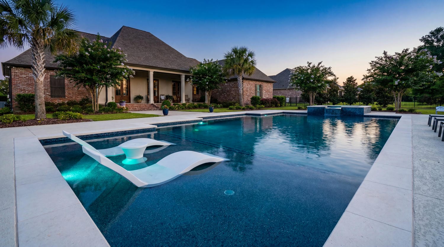 Louisiana brick home with a sprawling backyard pool
